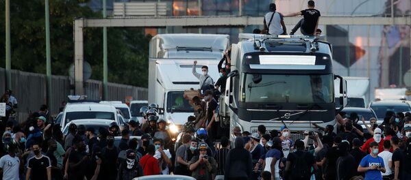 People block the road as they attend a banned demonstration planned in memory of Adama Traore, a 24-year old black Frenchman who died in a 2016 police operation which some have likened to the death of George Floyd in the United States, near the courthouse in Paris, France June 2, 2020 - Sputnik International