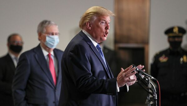 U.S. President Donald Trump talks to reporters as Senate Majority Leader Mitch McConnell (R-KY) and other senators listen in their protective masks following a closed Senate Republican policy lunch meeting to discuss the response to the coronavirus disease (COVID-19) outbreak with senators on Capitol Hill in Washington, U.S., May 19, 2020. - Sputnik International