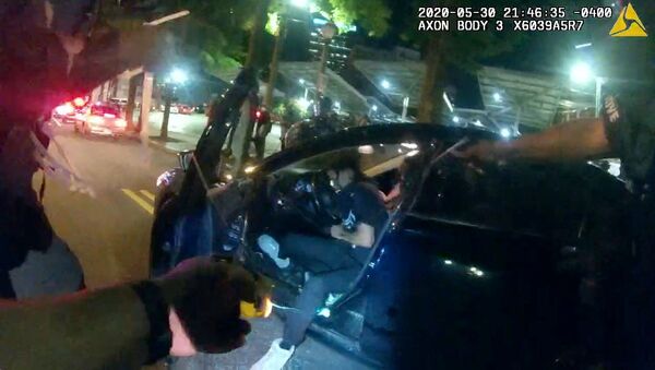 Still frame from Atlanta Police Department bodycam video footage of police officer Ivory Streeter, shows car driver Messiah Young being shot by a taser, during ongoing protests against the death in Minneapolis police custody of George Floyd, in Atlanta, Georgia, U.S. May 30, 2020 - Sputnik International