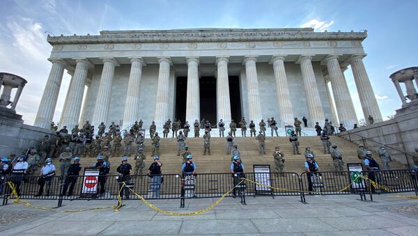 Law enforcement personnel stand guard on the steps of the Lincoln Memorial as protests spread across U.S. cities in reaction to the death in Minneapolis police custody of George Floyd, in Washington, D.C., U.S. June 2, 2020, in image obtained from social media - Sputnik International