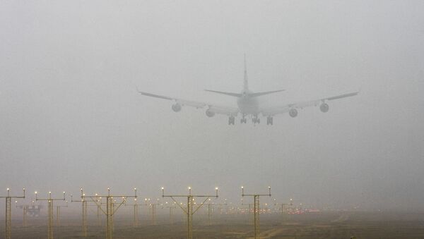 A plane lands at the Indira Gandhi International Airport through morning fog, in New Delhi, India - Sputnik International
