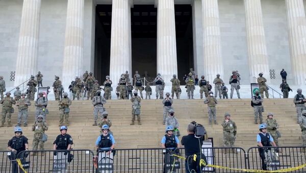 Law enforcement personnel stand guard on the steps of the Lincoln Memorial as protests spread across U.S. cities in reaction to the death in Minneapolis police custody of George Floyd, in Washington, D.C., U.S. June 2, 2020, in this still image obtained from a social media video - Sputnik International