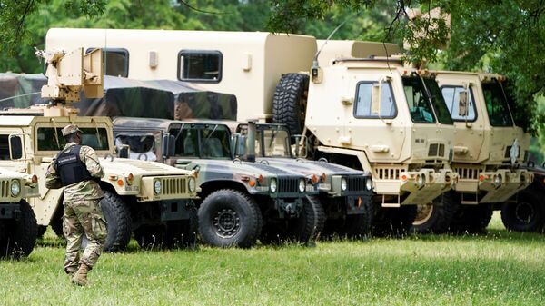 A member of the Washington, D.C. Army National Guard checks out their military vehicles staged at the DC Armory for use on the streets of Washington ahead of the expected resumption of protests over the death in police custody of George Floyd, in Washington, U.S., June 3, 2020. REUTERS/Joshua Roberts - Sputnik International