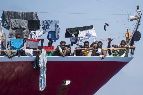 Migrants dry their clothes aboard a tourist boat some 20 kilometers from Malta, Tuesday, June 2, 2020. More than 400 migrants are living aboard pleasure cruise vessels, bobbing in the sea off Malta, many of them for weeks now. Rescued from human traffickers’ unseaworthy boats in several operations in the central Mediterranean since late April, the migrants, along with the Maltese government, are waiting for European Union countries to offer to take them. - Sputnik International