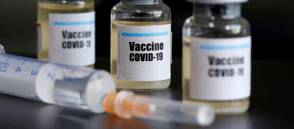 Small bottles labeled with a Vaccine COVID-19 sticker and a medical syringe are seen in this illustration taken taken April 10, 2020 Small bottles labeled with a Vaccine COVID-19 sticker and a medical syringe are seen in this illustration taken taken April 10, 2020 - Sputnik International