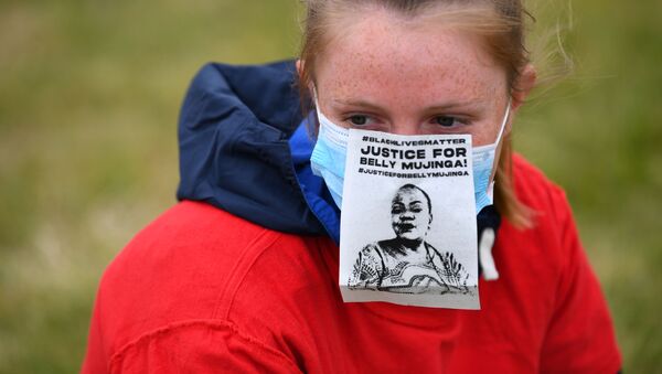 A woman wearing a face mask with a Justice For Belly Mujinga message is seen in Hyde Park during a Black Lives Matter protest following the death of George Floyd who died in police custody in Minneapolis, London, Britain, June 3, 2020 - Sputnik International