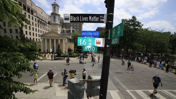 With St. John's Church in the background, people walk under a new street sign on Friday, June 5, 2020, in Washington. The section of 16th street in front of the White House is now officially 'Black Lives Matter Plaza,' District of Columbia Mayor Muriel Bowser tweeted. The black and white sign was put up to mark the change - Sputnik International