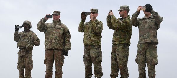 US soldiers take pictures with their cell phones during an artillery live fire event by the US Army Europe's 41st Field Artillery Brigade at the military training area in Grafenwoehr, southern Germany, on March 4, 2020. US soldiers take pictures with their cell phones during an artillery live fire event by the US Army Europe's 41st Field Artillery Brigade at the military training area in Grafenwoehr, southern Germany, on March 4, 2020. - Sputnik International