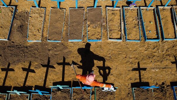 Aerial view showing a gravedigger standing at the Nossa Senhora Aparecida cemetery where COVID-19 victims are buried daily, in the neighbourhood of Taruma, in Manaus, Brazil, on 2 June 2020 during the novel coronavirus pandemic.  - Sputnik International