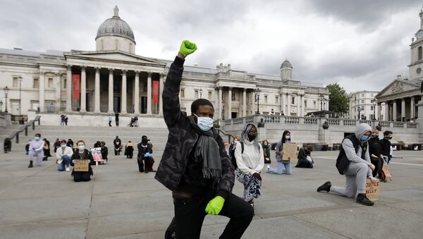 A protester makes a Black Lives Matter fist at a demonstration in Trafalgar Square in central London on June 5, 2020, to show solidarity with the Black Lives Matter movement in the wake of the killing of George Floyd, an unarmed black man who died after a police officer knelt on his neck in Minneapolis.  - Sputnik International
