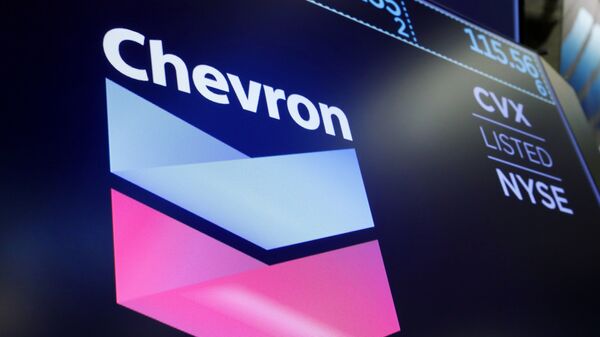 The logo for Chevron appears above a trading post on the floor of the New York Stock Exchange, Friday, Aug. 16, 2019 - Sputnik International