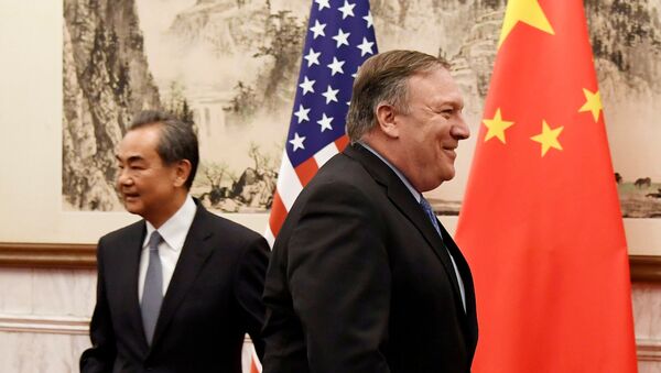 U.S. Secretary of State Mike Pompeo is seen near Chinese State Councilor and Foreign Minister Wang Yi before a meeting at the Diaoyutai State Guesthouse in Beijing, China October 8, 2018 - Sputnik International