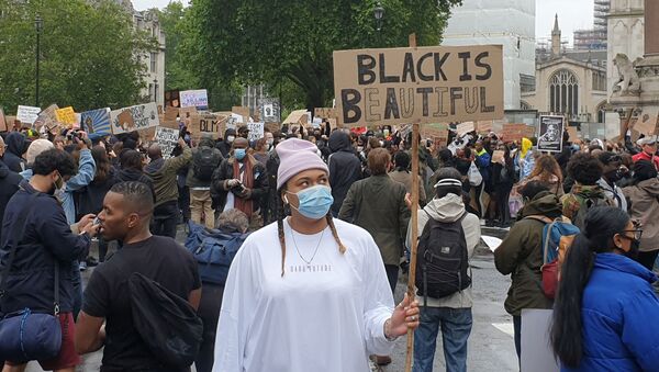 A demonstrators holds a sign during a Black Lives Matter protest in Parliament Square, following the death of George Floyd who died in police custody in Minneapolis, in London, Britain, June 6, 2020 - Sputnik International