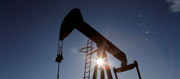 The sun is seen behind a crude oil pump jack in the Permian Basin in Loving County, Texas, U.S., November 22, 2019. Picture taken November 22, 2019 - Sputnik International