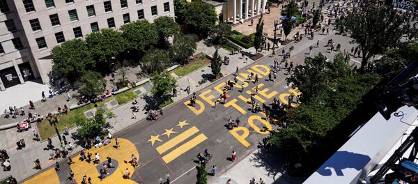 A sign painted by protesters stating Defund the Police is seen next to a Black Lives Matter sign as people demonstrate against the death in Minneapolis police custody of George Floyd, near the White House in Washington, U.S., June 7, 2020 A sign painted by protesters stating Defund the Police is seen next to a Black Lives Matter sign as people demonstrate against the death in Minneapolis police custody of George Floyd, near the White House in Washington, U.S., June 7, 2020 - Sputnik International