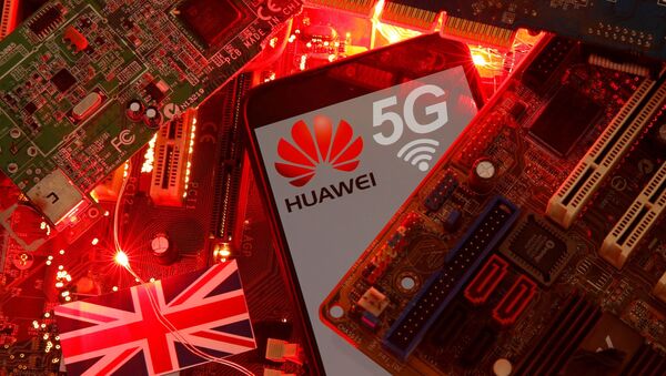FILE PHOTO: The British flag and a smartphone with a Huawei and 5G network logo are seen on a PC motherboard in this illustration picture taken January 29, 2020. REUTERS/Dado Ruvic/File Photo - Sputnik International