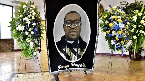 A picture of George Floyd and flowers are set up for a memorial service for Floyd, Saturday, June 6, 2020, in Raeford, N.C. Floyd died after being restrained by Minneapolis police officers on May 25 - Sputnik International