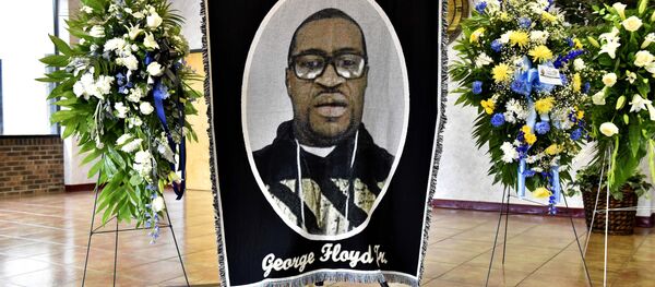 A picture of George Floyd and flowers are set up for a memorial service for Floyd, Saturday, June 6, 2020, in Raeford, N.C. Floyd died after being restrained by Minneapolis police officers on May 25 - Sputnik International