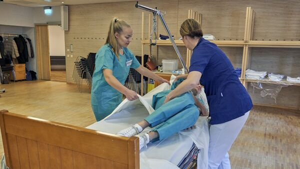 Former Scandinavian Airlines flight attendants learn basic skills on to assist in nursing homes and hospitals due to the coronavirus outbreak, in Stockholm, Wednesday, April 1, 2020 - Sputnik International