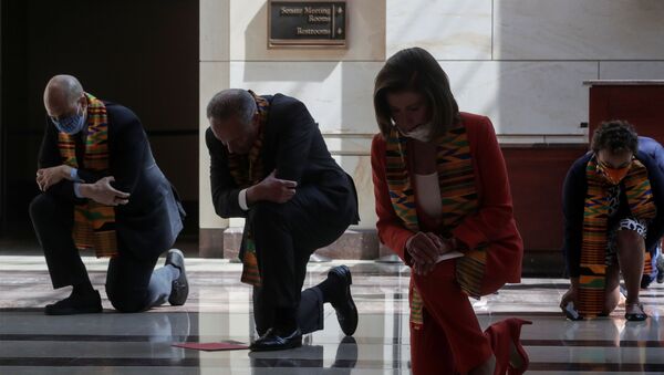 U.S. House Speaker Nancy Pelosi (D-CA) and Senate Minority Leader Chuck Schumer (D-NY) kneel with Congressional Democrats during a moment of silence to honor George Floyd, Breonna Taylor, Ahmaud Arbery and others inside Emancipation Hall after weeks of protests against racial inequality in the aftermath in Minneapolis police custody of Floyd, at the U.S. Capitol in Washington, U.S., June 8, 2020 - Sputnik International
