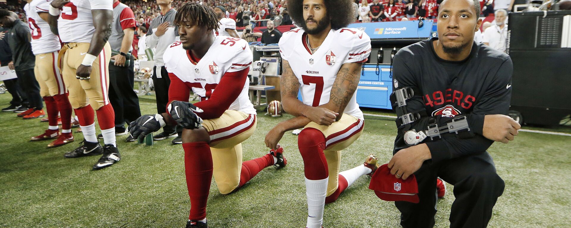 In this Dec. 18, 2016, file photo, San Francisco 49ers quarterback Colin Kaepernick (7) and outside linebacker Eli Harold (58) kneel during the playing of the national anthem before an NFL football game against the Atlanta Falcons in Atlanta - Sputnik International, 1920, 18.06.2020