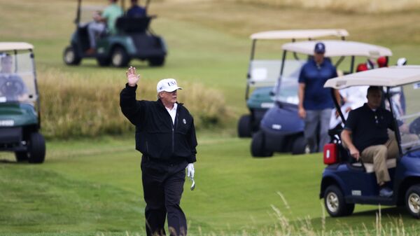 FILE - In this July 14, 2018 file photo, President Donald Trump waves to protesters while playing golf at Turnberry golf club, in Turnberry, Scotland - Sputnik International