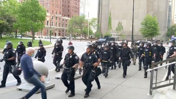 An elderly man falls after appearing to be shoved by riot police during a protest against the death in Minneapolis police custody of George Floyd, in Buffalo, New York, U.S. June 4, 2020 in this still image taken from video - Sputnik International