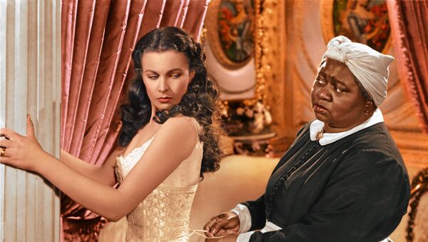 In this image released by Turner Classic Movies, Vivien Leigh appears in character as Scarlett O'Hara, left, and Hattie McDaniel as Mammy, in the film, Gone with the Wind.  75 years after the premiere of the movie, Gone with the Wind, research is shedding light on the racial tensions that existed at the time between the producer and City of Atlanta officials. Emory University film studies professor, Matthew Bernstein, has conducted extensive research into the archives of the film's producer, David O. Selznick. His findings illustrate some of Selznick's concerns with the city's treatment of the film's black stars at the Dec. 15, 1939 premiere - Sputnik International