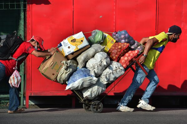 Two men carry a cart loaded with fresh goods at a street in Tegucigalpa, Honduras, on June 8, 2020, after the government announced the resumption of economic activity, amid the COVID-19 pandemic.  - Sputnik International