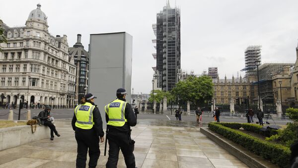 Police officers walk past a boarded-up statue of British wartime Prime Minister Winston Churchill on Parliament square in central London on June 12, 2020 - Sputnik International