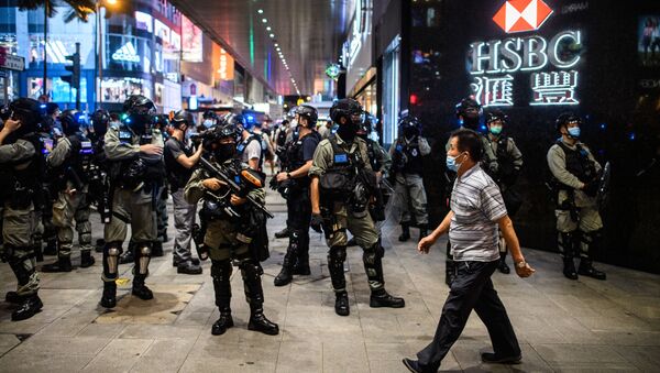 Police secure an area in the Central district of Hong Kong on June 9, 2020, as the city marks the one-year anniversary since pro-democracy protests erupted following opposition to a bill allowing extraditions to mainland China.  - Sputnik International