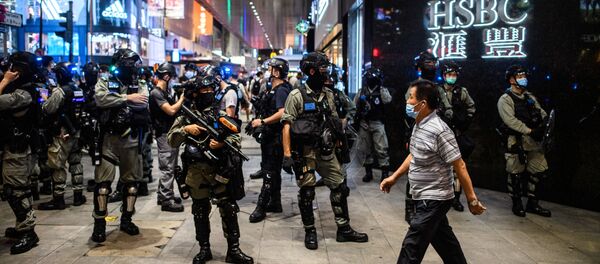 Police secure an area in the Central district of Hong Kong on 9 June 2020, as the city marks the one-year anniversary since pro-democracy protests erupted following opposition to a bill allowing extraditions to mainland China.  - Sputnik International