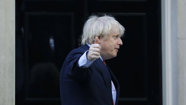 Britain's Prime Minister Boris Johnson gestures after applauding on the doorstep of 10 Downing Street, during the weekly Clap for our Carers, in London, Thursday, May 28, 2020 - Sputnik International