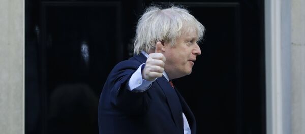 Britain's Prime Minister Boris Johnson gestures after applauding on the doorstep of 10 Downing Street, during the weekly Clap for our Carers, in London, Thursday, May 28, 2020 - Sputnik International