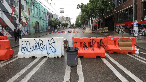 Barricades line a street near a closed Seattle police precinct Tuesday, June 9, 2020, in Seattle, following protests over the death of George Floyd, a black man who was in police custody in Minneapolis. - Sputnik International