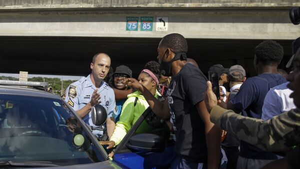 Protesters block a Georgia State Patrol official from leaving, Saturday, June 13, 2020, near the Wendy's restaurant where Rayshard Brooks was shot and killed by police Friday evening following a struggle in the restaurant's drive-thru line in Atlanta. - Sputnik International
