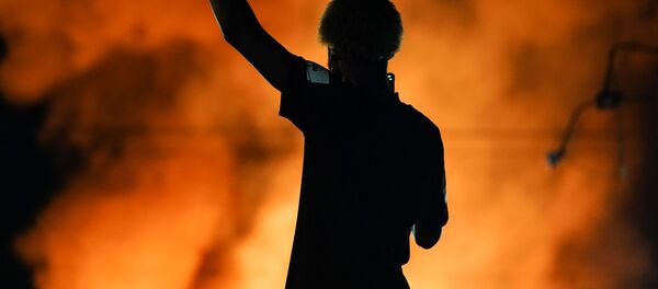 A protester watches as a Wendy’s burns following a rally against racial inequality and the police shooting death of Rayshard Brooks, in Atlanta, Georgia, U.S. June 13, 2020. A protester watches as a Wendy’s burns following a rally against racial inequality and the police shooting death of Rayshard Brooks, in Atlanta, Georgia, U.S. June 13, 2020. - Sputnik International
