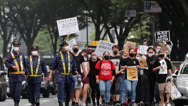 People wearing face masks march during a Black Lives Matter protest following the death in Minneapolis police custody of George Floyd, in Tokyo, Japan June 14, 2020 - Sputnik International