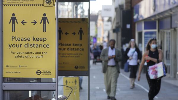 Signs advise people to social distance on a bus stop along a high street, in London, Tuesday, May 19, 2020, after the introduction of measures to bring the country out of lockdown amid the coronavirus pandemic.  - Sputnik International