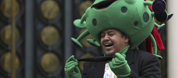 A street artist costumed as the new coronavirus laughs during a protest demanding the resumption of economic activities after not being able to earn a living since March because of the restrictions to curb the spread of COVID-19 in Mexico City, Thursday, June 11, 2020. A street artist costumed as the new coronavirus laughs during a protest demanding the resumption of economic activities after not being able to earn a living since March because of the restrictions to curb the spread of COVID-19 in Mexico City, Thursday, June 11, 2020. - Sputnik International