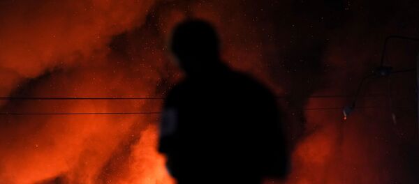 A protester watches as a Wendy’s burns following a rally against racial inequality and the police shooting death of Rayshard Brooks, in Atlanta, Georgia, U.S. June 13, 2020. - Sputnik International