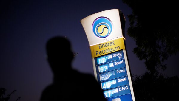FILE PHOTO: A Bharat Petroleum oil pump station displays the price of unleaded petrol (0.89$) and Diesel (0.66$) as a pedestrian walks past in New Delhi, India, February 3, 2016. - Sputnik International