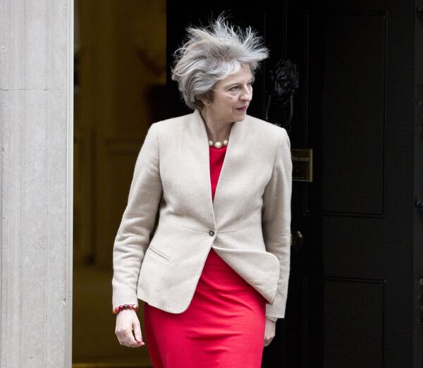 The wind catches the hair of former British Prime Minister Theresa May as she comes out of Downing Street to greet New Zealand Prime Minister Bill English in London on January 13, 2017 - Sputnik International