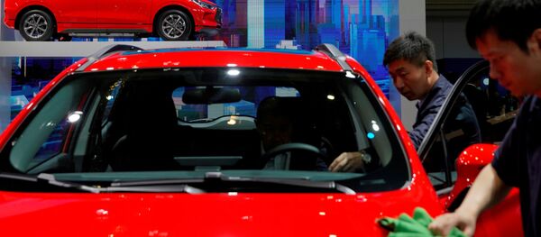 Men clean a BYD electric vehicle (EV) e2 displayed during the media day for Shanghai auto show Men clean a BYD electric vehicle (EV) e2 displayed during the media day for Shanghai auto show - Sputnik International