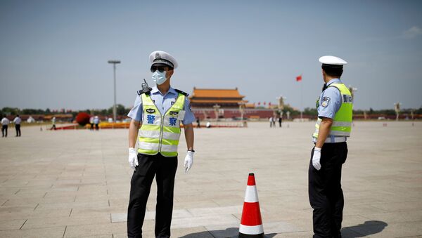 Police officers wearing face masks following the coronavirus disease (COVID-19) outbreak stand on Tiananmen Square before the closing session of the National People's Congress (NPC) in Beijing, China May 28, 2020. - Sputnik International