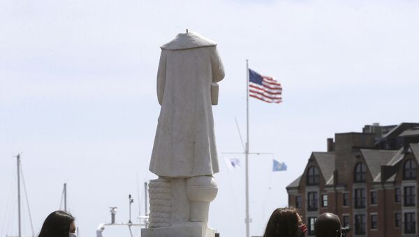 Passers-by walk near a damaged Christopher Columbus statue, Wednesday, June 10, 2020, in a waterfront park near the city's traditionally Italian North End neighborhood, in Boston - Sputnik International