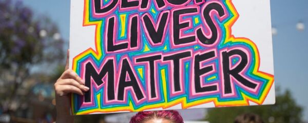 A participant holding a sign reading Black Lives Matter takes part in an All Black Lives Matter march, organized by Black LGBTQ+ leaders, in the aftermath of the death in Minneapolis police custody of George Floyd, in Hollywood, Los Angeles, California, U.S., June 14, 2020 - Sputnik International