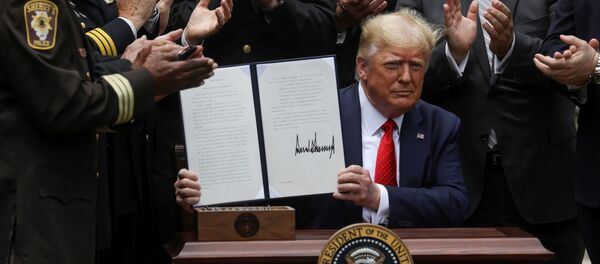 U.S. President Donald Trump displays an executive order on police reform during a signing ceremony in the Rose Garden at the White House in Washington, U.S., June 16, 2020. - Sputnik International
