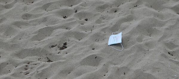 A protective face mask lies on the sand at Playa de Palma beach ahead of Spain's official reopening of the borders June 21 following the coronavirus disease (COVID-19) outbreak, in Palma de Mallorca, Spain June 16, 2020. A protective face mask lies on the sand at Playa de Palma beach ahead of Spain's official reopening of the borders June 21 following the coronavirus disease (COVID-19) outbreak, in Palma de Mallorca, Spain June 16, 2020. - Sputnik International