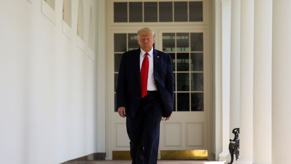 U.S. President Donald Trump walks along the Colonnade as he arrives prior to signing an executive order on police reform at a ceremony in the Rose Garden at the White House in Washington, U.S., June 16, 2020 - Sputnik International